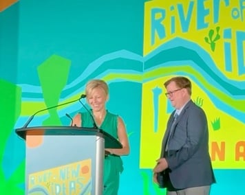 Dr. Angela Robbins at the podium with Steven Stout.