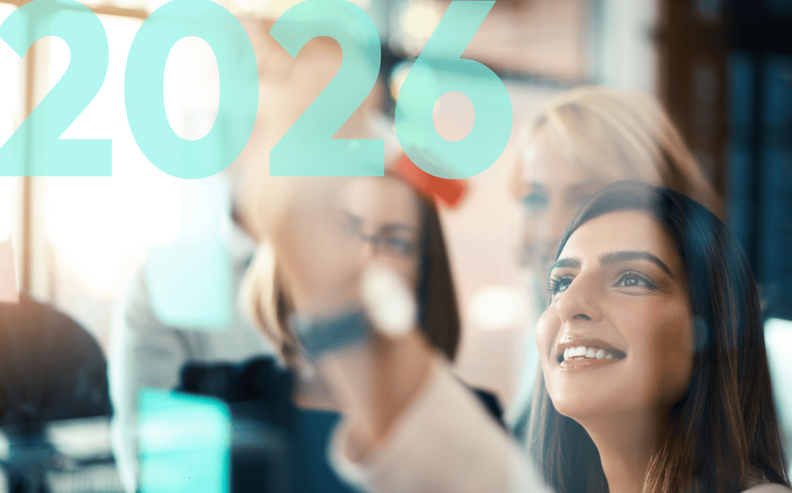 Professionals looking up at a light board in a meeting with the words 2026