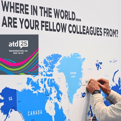 Person marking countries on a wall map.
