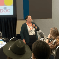 Dr. Diana Brandon speaking to a group at an association conference.