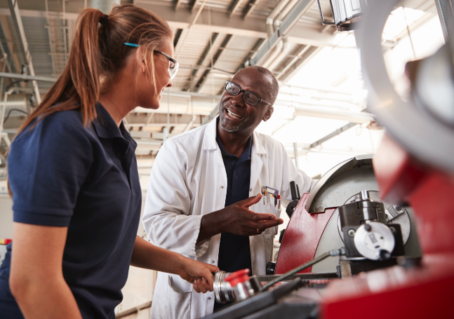Auto technicians looking into the hood of a car.